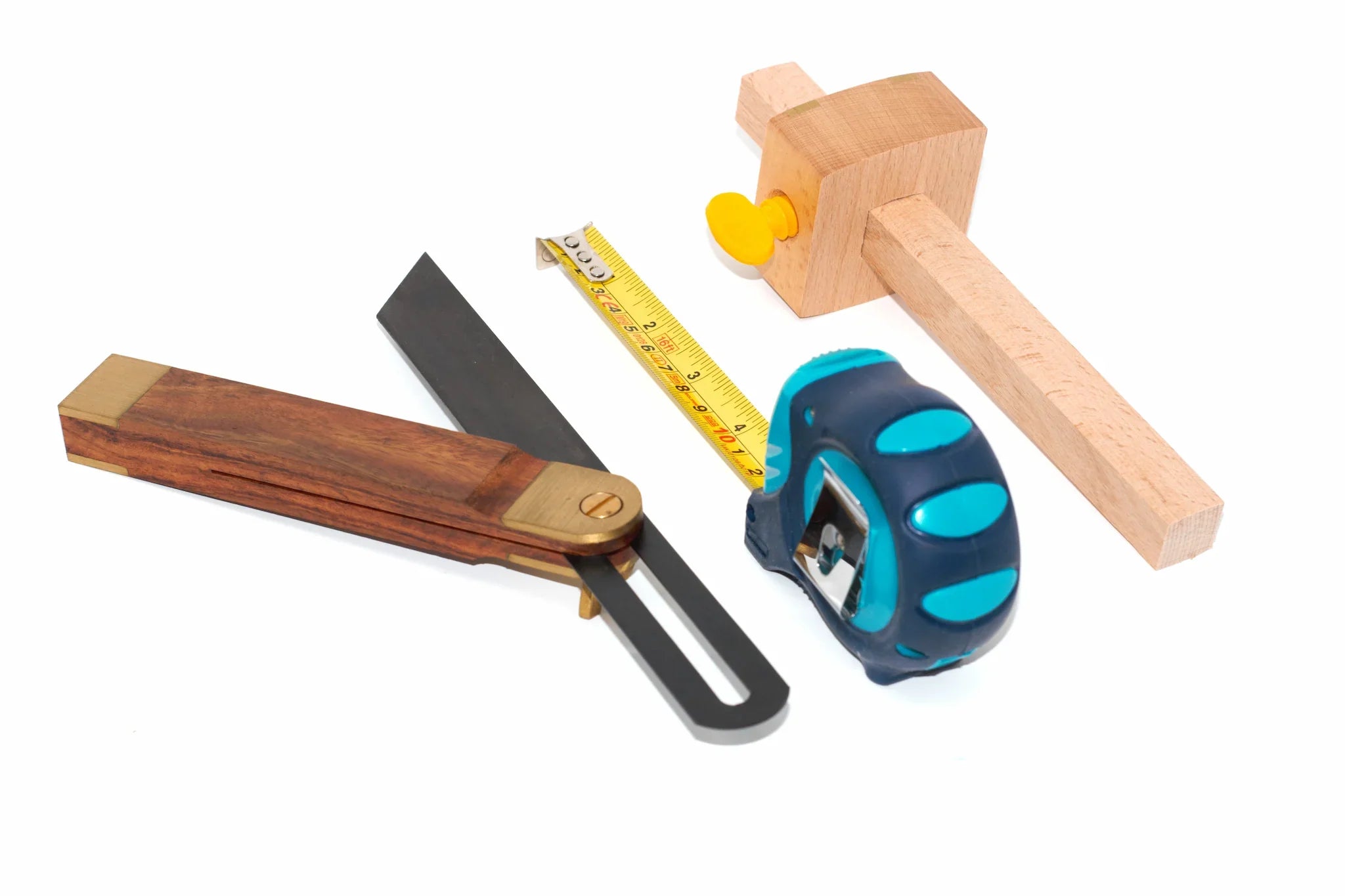A sliding bevel, tape measure and a marking gauge from the Cherry tree tools range lined up diagonally on a white background