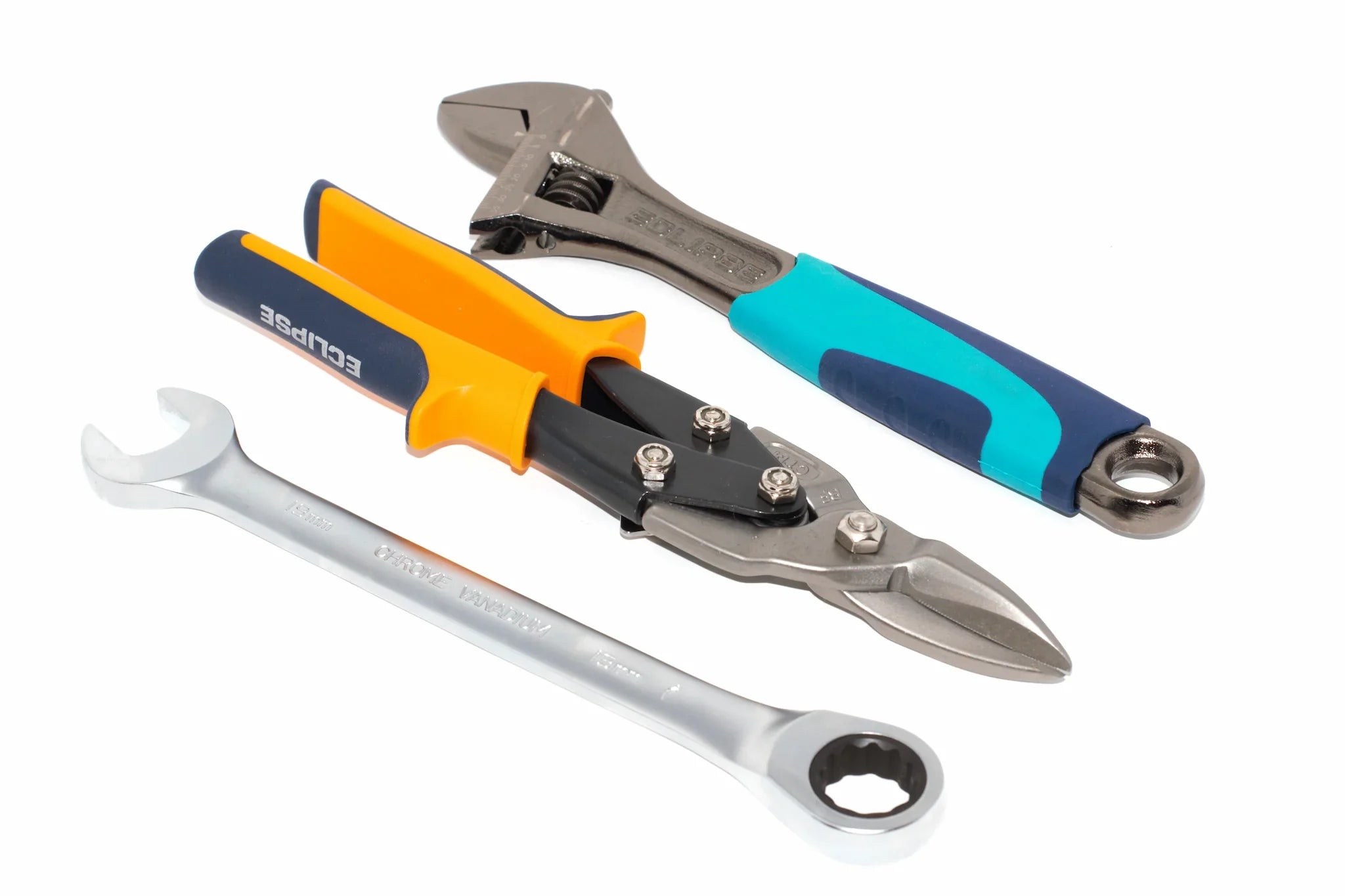 An adjustable wrench, tin snips and a ratchet spanner from the Cherry Tree Tools range lined up diagonally on a white background