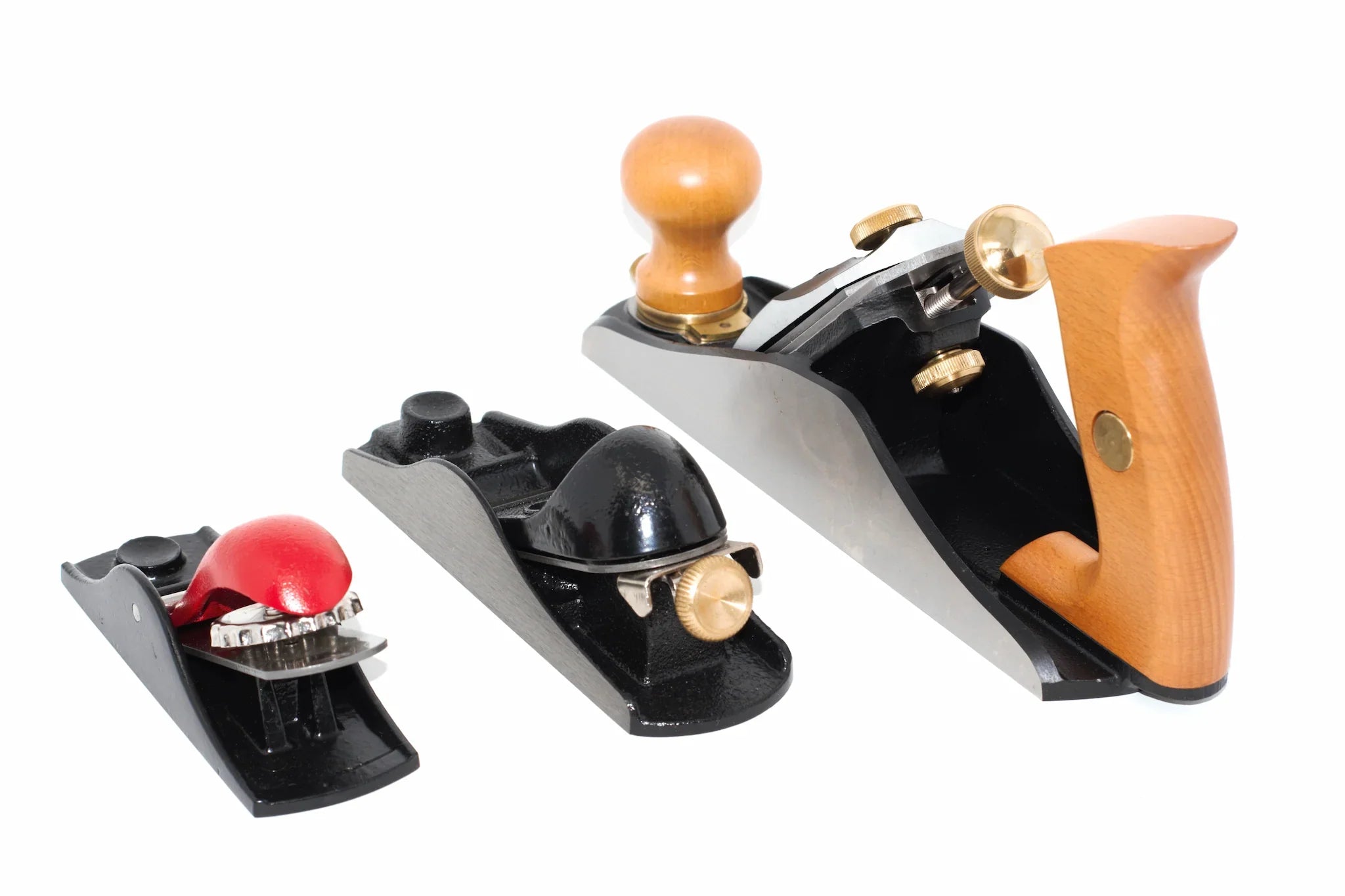 A collection of 3 hand planes lined up side by side rear view