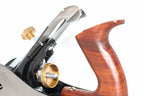 Faithfull no 10 rebate plane -Close-up of a woodworking hand plane showing the polished wooden handle, brass adjustment knobs, and metal cutting edge against a white background.