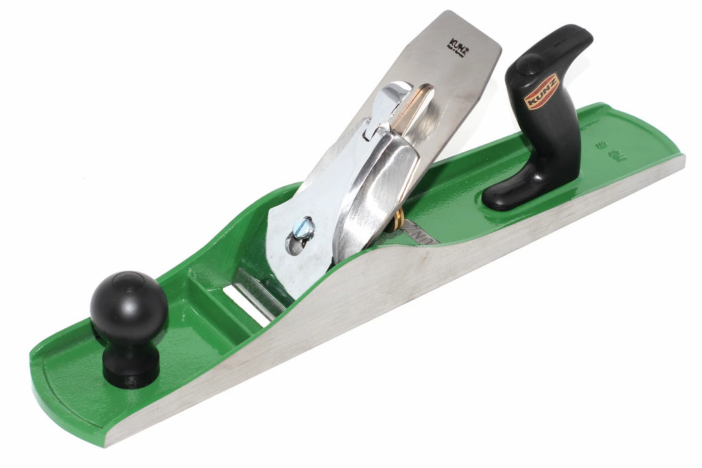 A Kunz no 6 fore plane corrugated sole  with a green cast iron main body, silver steel blade, and black knobs, shown on a white background. 