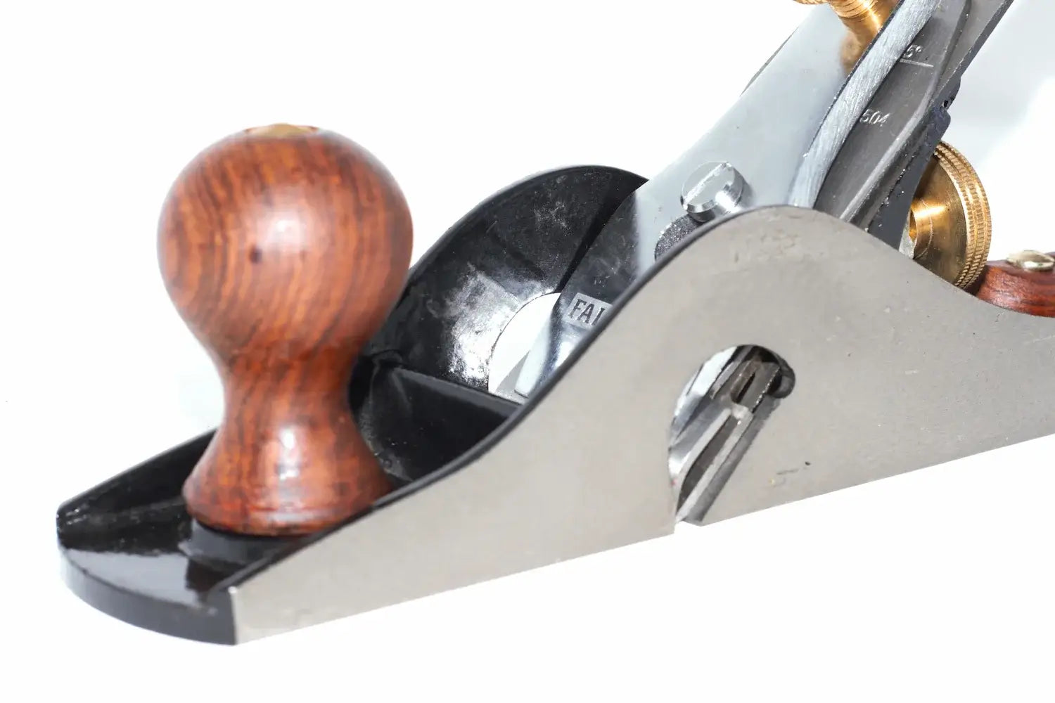 Faithfull no 10 rebate plane close up with a polished metal body, and a round  wooden knob, shown on a white background.