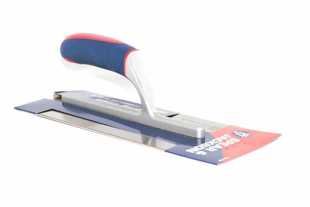 Spear & Jackson plastering trowel with a blue and red soft grip handle and a silver metal blade, shown on its retail cardboard packaging against a white background.