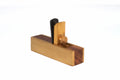 Silverline Miniature Scraper Plane with a rectangular light wood base, darker wood end pieces, a vertical light wood blade, and a black handle, shown on a plain white background.